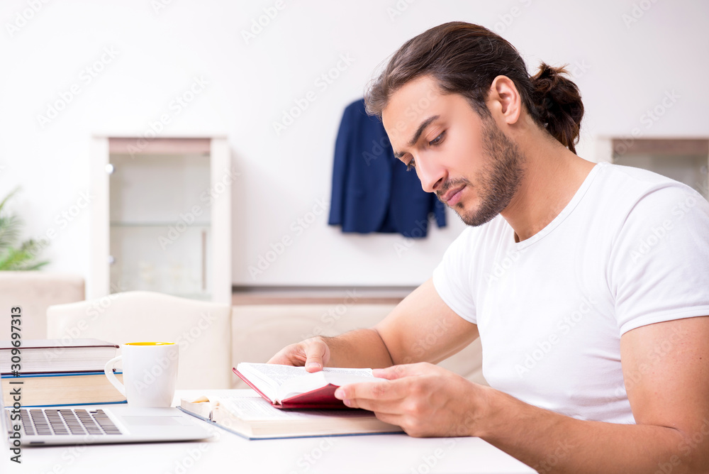 Young male student preparing for exams at home Young male student preparing for exams at home