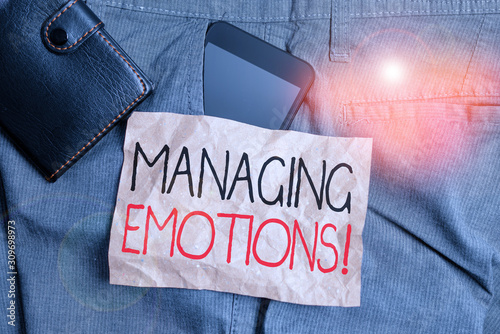 Writing note showing Managing Emotions. Business concept for ability be open to feelings and modulate them in oneself Smartphone device inside trousers front pocket with wallet