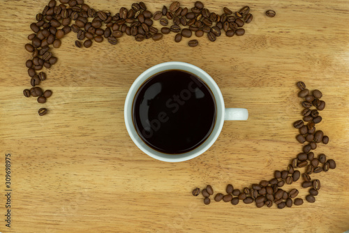 cup of coffee on table with beans