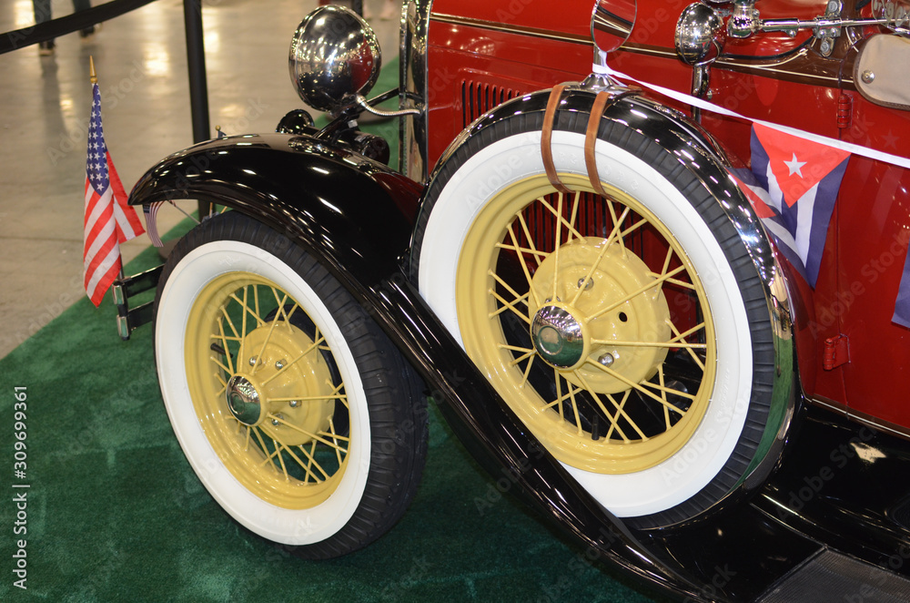 Bright yellow spoked wire wheels on an antique automobile Stock Photo