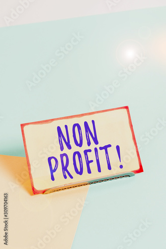 Text sign showing Non Profit. Business photo showcasing not making or conducted primarily to make profit organization Paper placed tilted above buffer wire on soft pastel multi colours backdrop