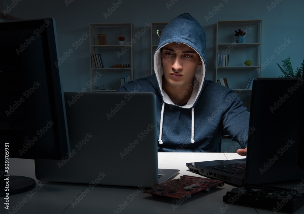 Hacker hacking computer at night Hacker hacking computer at night