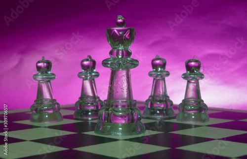 chess pieces from a Board game on a Board with a metallic surface of an unusual background