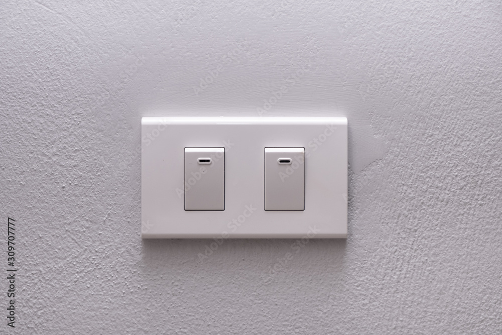 Electricity switch or lamp switch on white wall Electricity switch or lamp switch on white wall