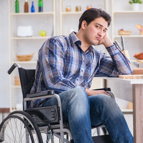 Disabled young man husband working in kitchen