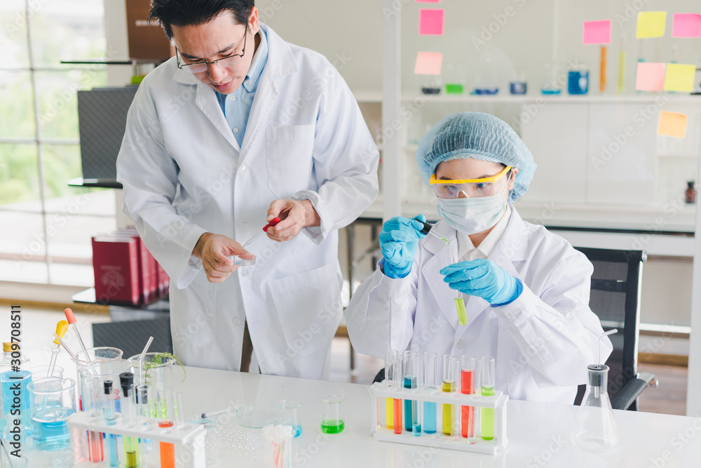 Asian scientists, men and women are helping to test and analyze various color chemicals in laboratories that have many scientific equipment. Asian scientists, men and women are helping to test and analyze various color chemicals in laboratories that have many scientific equipment.