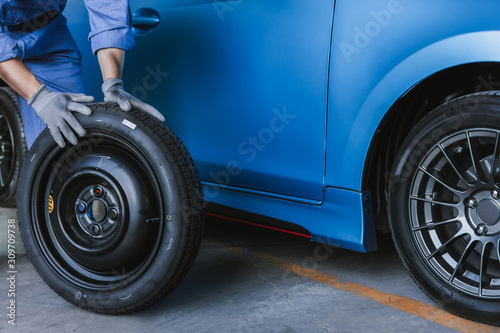 Asian man car inspection Measure quantity Inflated Rubber tires car.Closeup hand holding © OATZ TO GO FACTORY