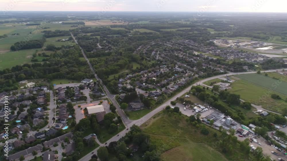 Night Time Dusk Aerial Pan Left To Right Over Small Towns Near Farming Community Land