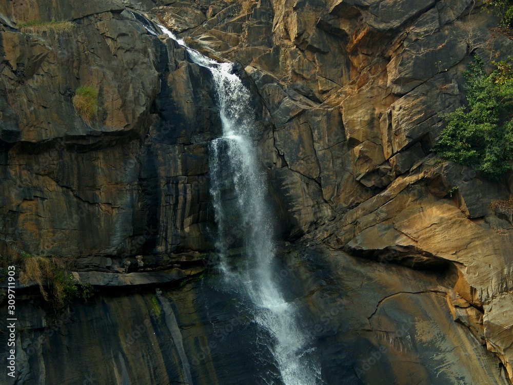 water splashing on rocks to form a waterfall at hundru falls, Ranchi, India