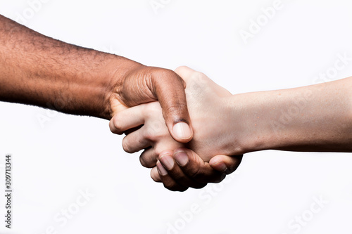 African man and Caucasian woman shake hands, studio shot, isolated