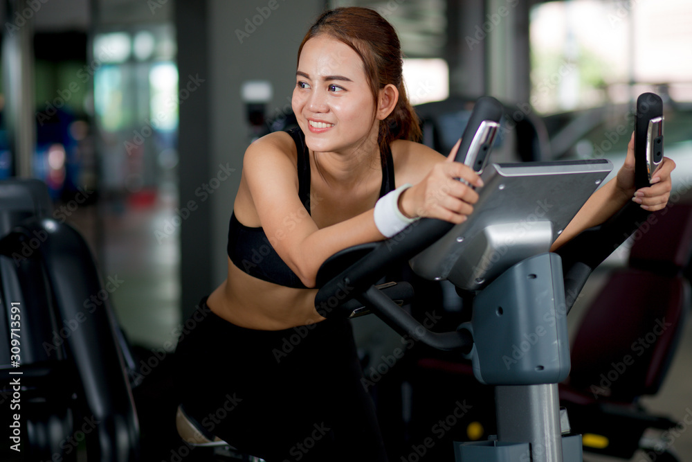 Young fit woman running on treadmill in modern fitness gym. Young fit woman running on treadmill in modern fitness gym.