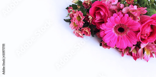 Festive floral arrangement in bright colors. Pink flowers on white background. Gerbera, astromeria and cloves in a luxury bouquet. Background for greetings, invitations, cards for wedding, birthday. photo