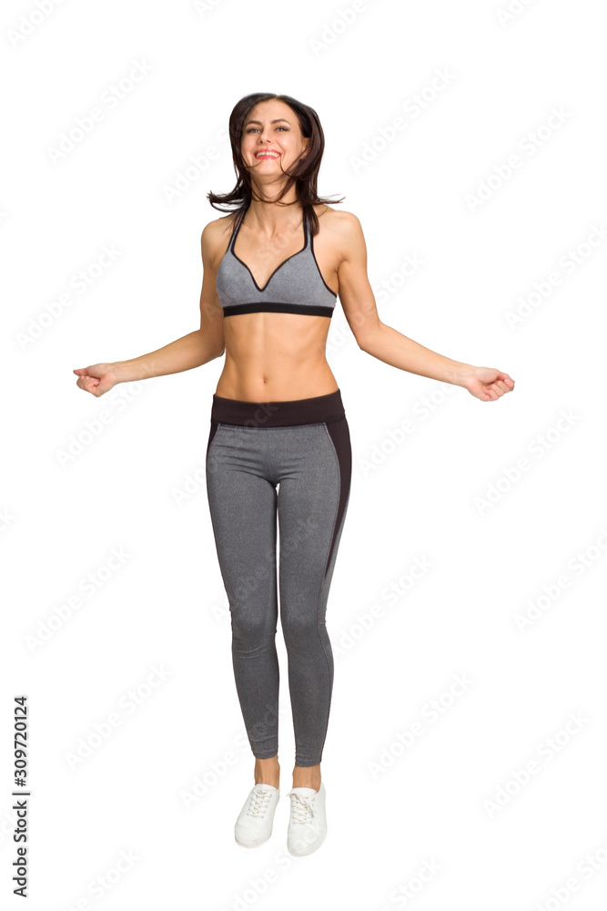 girl in gray sweatpants and top jumps. Isolate white background girl in gray sweatpants and top jumps. Isolate white background