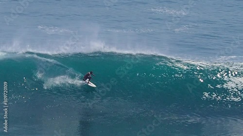 Surfer Riding a Big Wave in Uluwatu, Bali. Surfing on Bali, Uluwatu Surf Spot.