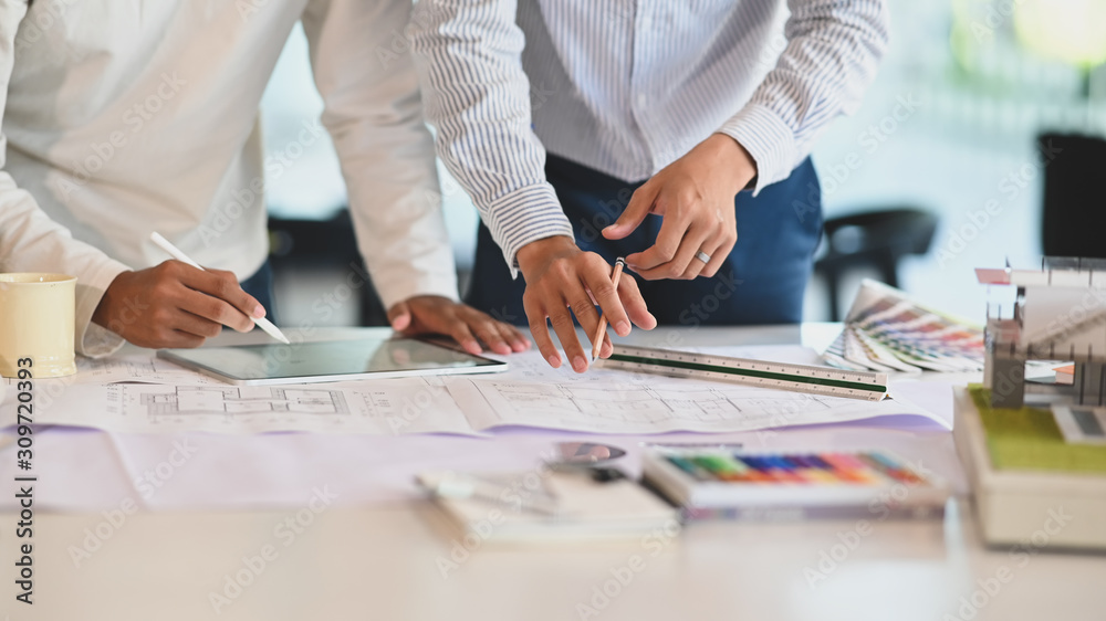 Architecture brainstorming with tablet and blueprints. Architecture brainstorming with tablet and blueprints.