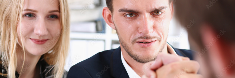 Two alpha man in suit hold hands in wrestle Two alpha man in suit hold hands in wrestle