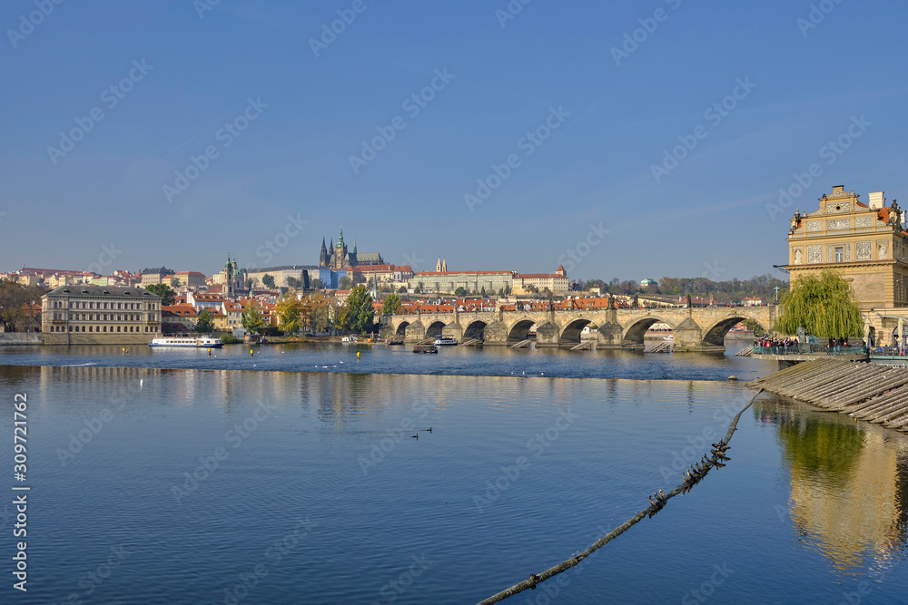 Scenic panorama with Prague Castle (Prazsky hrad), Charles bridge (Karluv most) and Vlatva river in capital of Czech Republic Prague. Beautiful summer sunny cityscape of the biggest city of Czechia