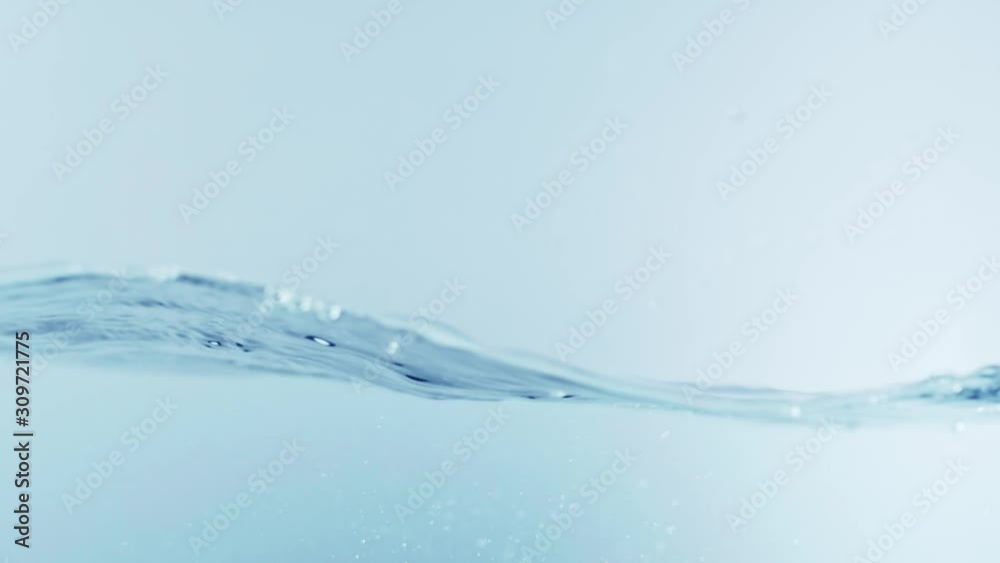 The clean water surface in slow motion fills the screen with water splashing shop the water drop and waving liquid surface with an air bubble. 1080p 29.97fps The clean water surface in slow motion fills the screen with water splashing shop the water drop and waving liquid surface with an air bubble. 1080p 29.97fps