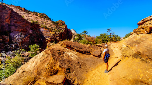 Active Senior woman hiking the Canyon Overlook Trail in Zion National Park, Utah, United States