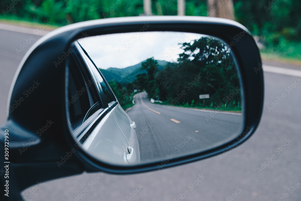 Landscape in the sideview mirror of a car. side rear-view mirror on a car.