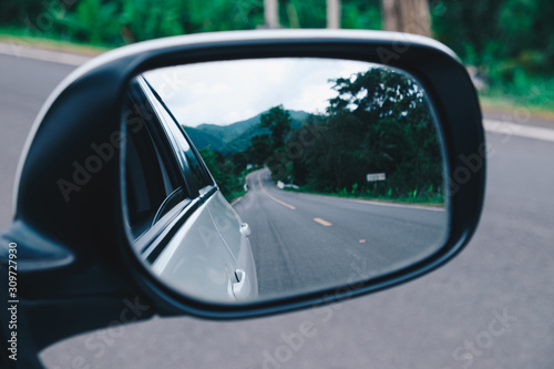 Landscape in the sideview mirror of a car. side rear-view mirror on a car.
