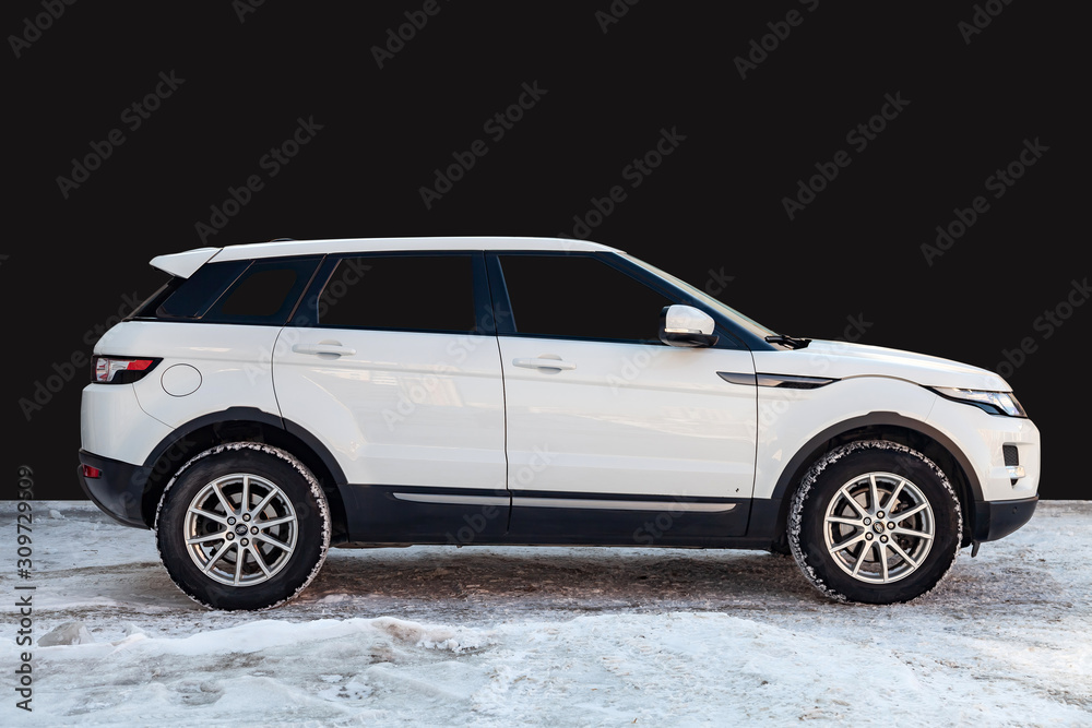 Side view of Range Rover Land Rover Evoque in white color after cleaning  before sale standing on snow with black wall background Photos | Adobe Stock