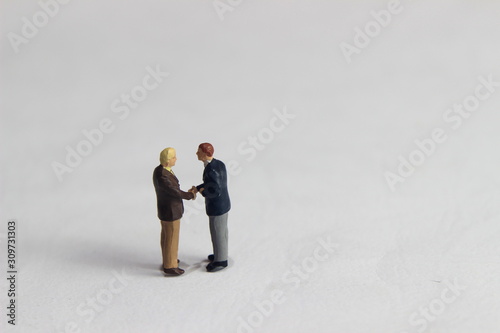 Gray Backgrond, Simple Illustration Photo for Mini Figure Two Man Toy Handshaking for Business Agreement 