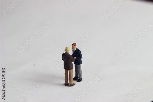 Gray Backgrond, Simple Illustration Photo for Mini Figure Two Man Toy Handshaking for Business Agreement 