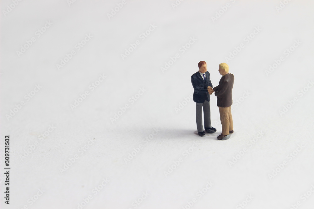 Gray Backgrond, Simple Illustration Photo for Mini Figure Two Man Toy Handshaking for Business Agreement Gray Backgrond, Simple Illustration Photo for Mini Figure Two Man Toy Handshaking for Business Agreement