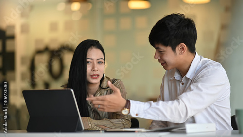 Asian business people they meeting with digital tablet on modern office.