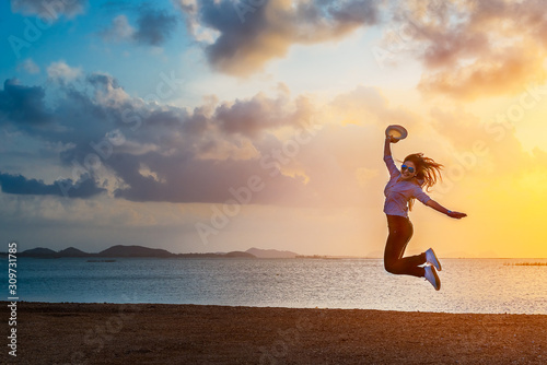 Summer lifestyle traveler woman joy reraxing and jumping on lakeside at sunset time  Beautiful destination natural in Asia  Summer holiday outdoor vacation travel trip