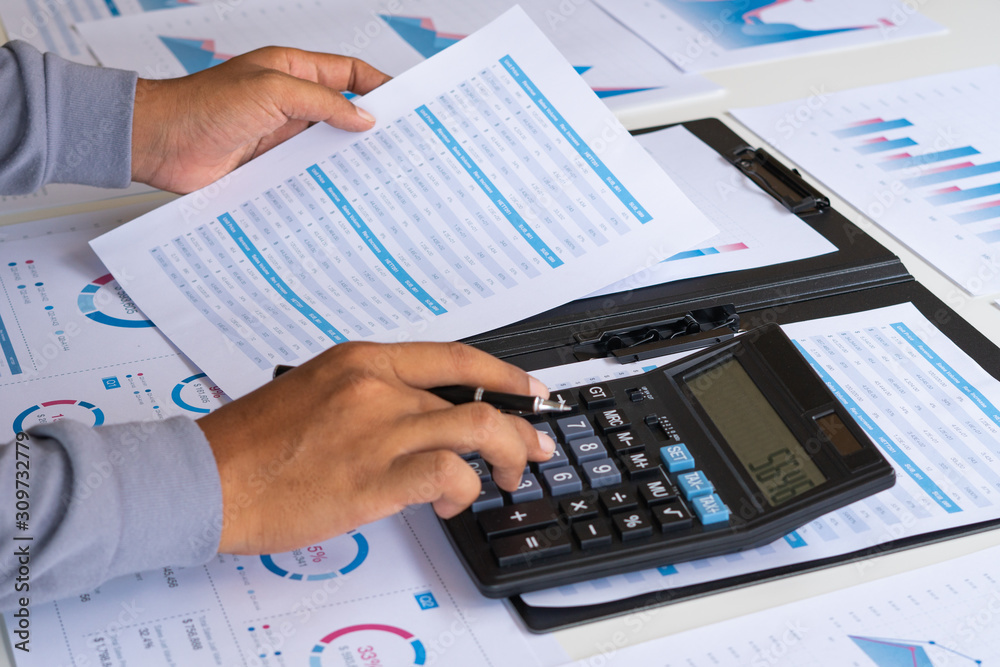 businessman working calculate data document graph chart report marketing research development planning management strategy analysis financial accounting. Business office concept. businessman working calculate data document graph chart report marketing research development planning management strategy analysis financial accounting. Business office concept.