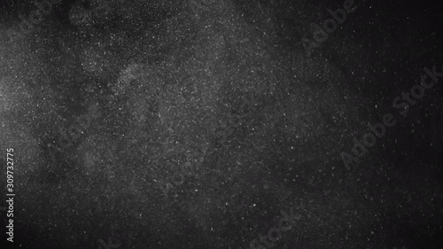 Natural Organic Dust Particles Floating On Black Background. Dynamic Dust Particles Randomly Float In Space With Fast And Slow Motion. Shimmering Glittering Colored Particles With Bokeh In The Air. photo