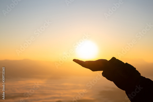 Silhouette of a woman with hands raised in the sunset concept for religion, worship, prayer and praise, Religious concepts