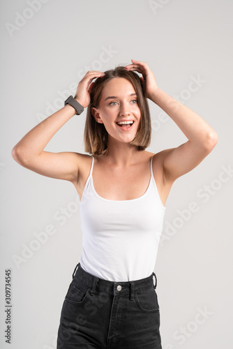 Smiling young woman touching her hair