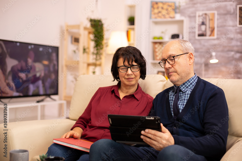 Beautiful old couple using a digital tablet to chat with their family Beautiful old couple using a digital tablet to chat with their family
