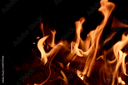 warm fire flames lambent flicker black background space for text