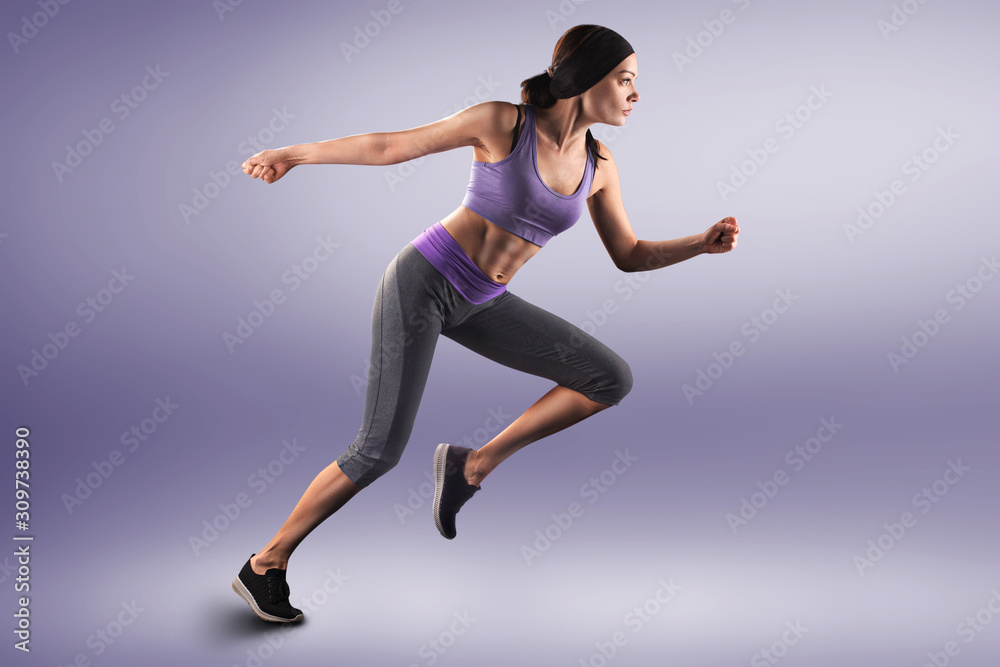 woman running on studio blue isolated background