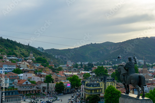 Tbilisi, Georgia, JULY, 2019: Stone equestrian statue rider with sword and raised hand on the river Bank