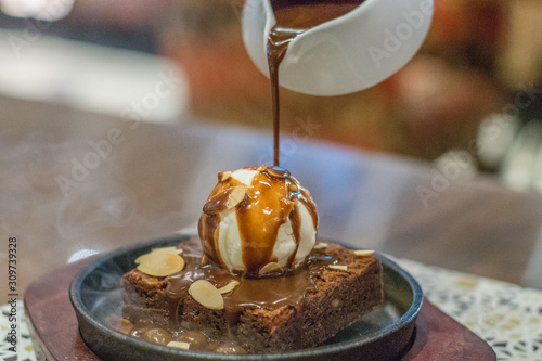 Canvas-taulu hot chocolate brownie on sizzling hot plate with vanilla ice cream and topped wi