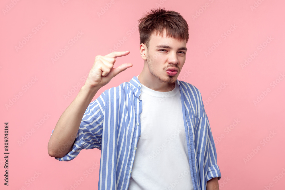 Portrait of unhappy young brown-haired man with small beard and mustache in casual shirt showing little bit gesture, asking more with annoyed expression. indoor studio shot isolated on pink background Portrait of unhappy young brown-haired man with small beard and mustache in casual shirt showing little bit gesture, asking more with annoyed expression. indoor studio shot isolated on pink background