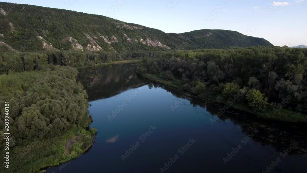The remain of the reef of the ancient sea, composed of limestone - shikhan Kushtau on a summer day. The main river of Bashkiria - Belaya. Aerial view. The remain of the reef of the ancient sea, composed of limestone - shikhan Kushtau on a summer day. The main river of Bashkiria - Belaya. Aerial view.