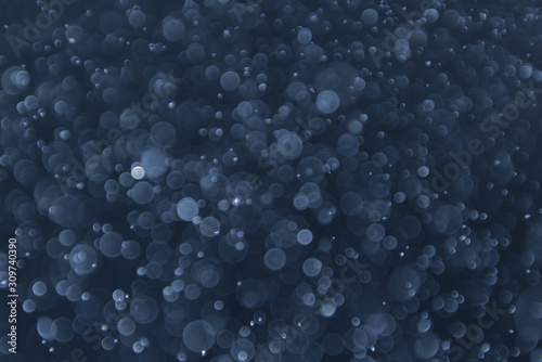 abstract sparkle bokeh light effect with navy blue background © DEEP PIXEL