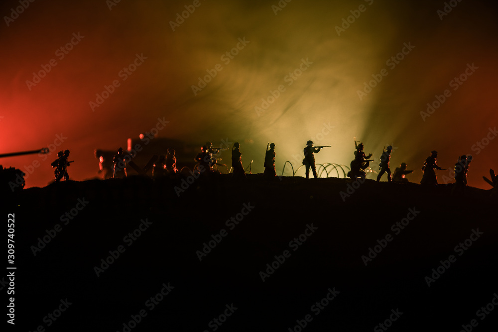 War Concept. Military silhouettes fighting scene on war fog sky background, World War German Tanks Silhouettes Below Cloudy Skyline At night. Attack scene. Armored vehicles and infantry.