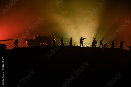 War Concept. Military silhouettes fighting scene on war fog sky background, World War German Tanks Silhouettes Below Cloudy Skyline At night. Attack scene. Armored vehicles and infantry.