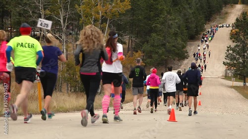Runners in an organized race running away from the camera