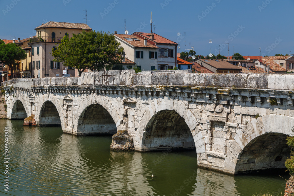 RIMINI / ITALY - JULY 2015: View to ancient Roman bridge in the historic centre of Rimini, Italy