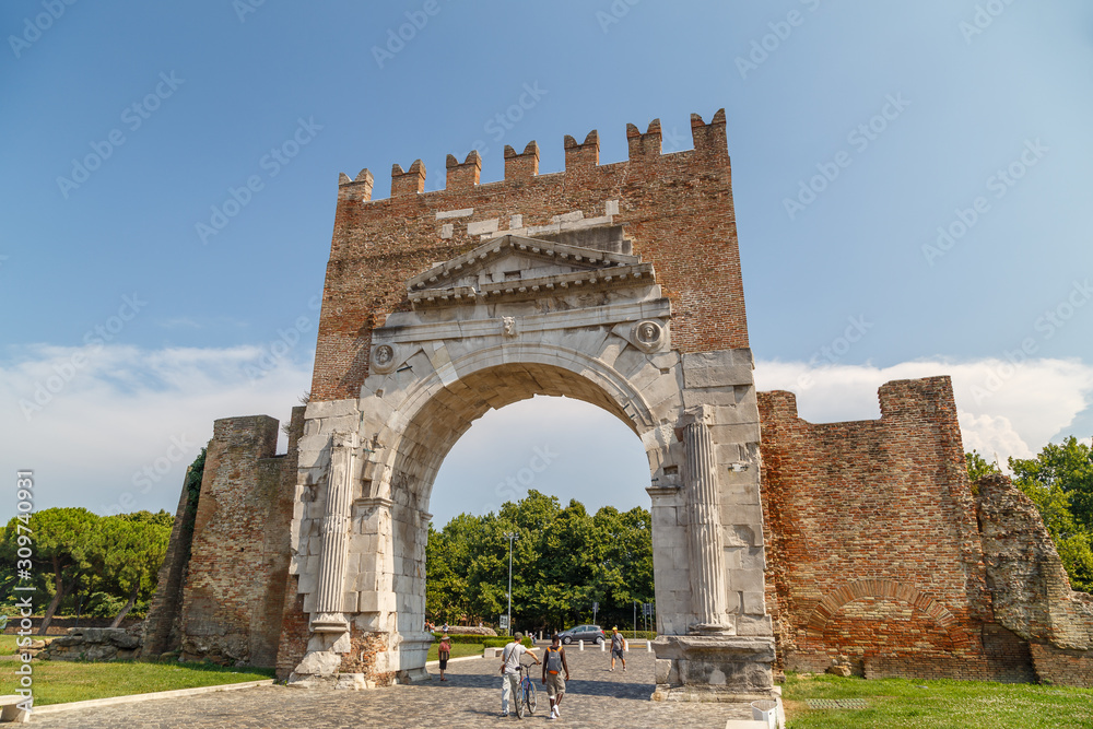 RIMINI / ITALY - JULY 2015: Roman triumphal arch converted into medieval gate in Rimini, Italy