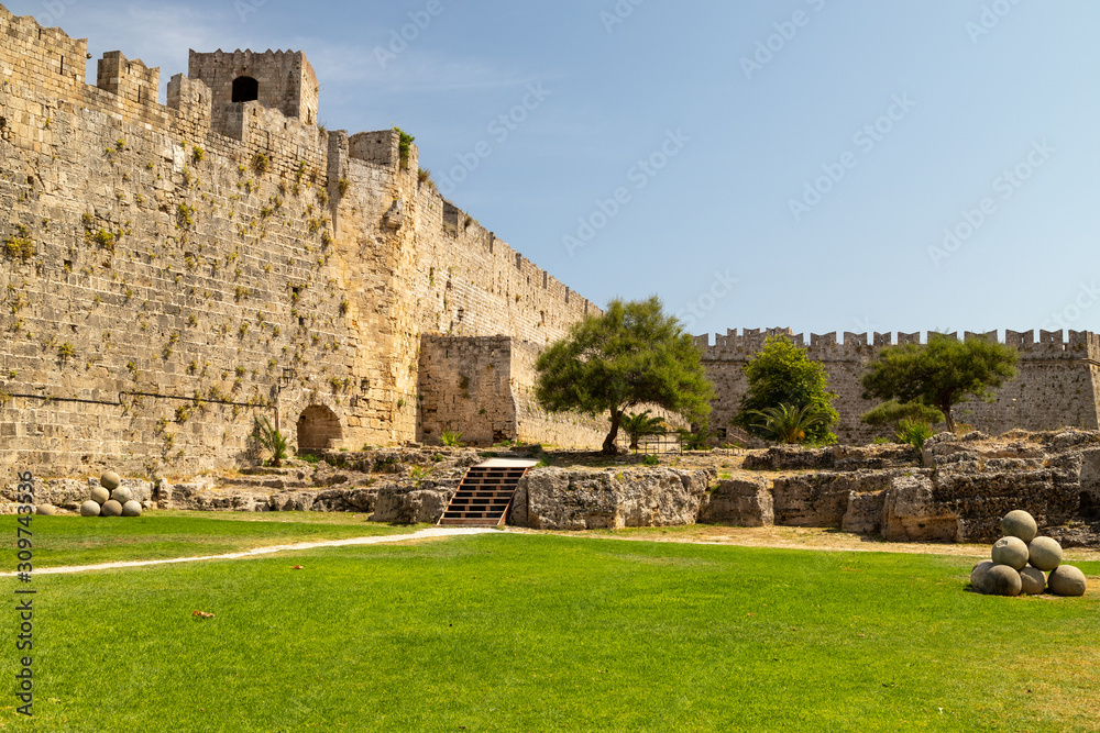 Along the ditch of the antique city wall in the old town of Rhodes city on a sunny day in summer