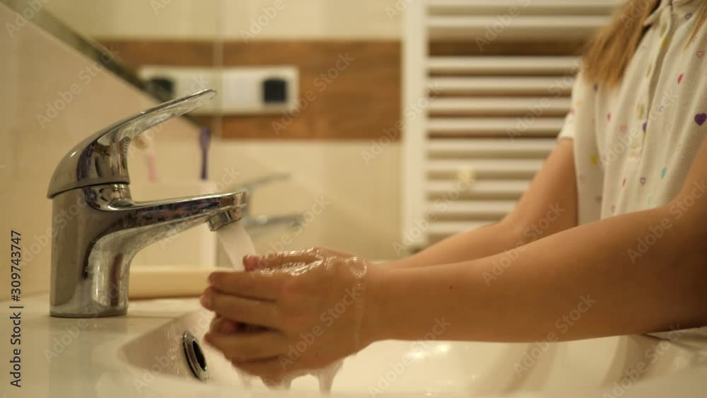 Cute kid girl hygiene washing hands lather with soap in bathroom in pajamas just after sleep in the morning Cute kid girl hygiene washing hands lather with soap in bathroom in pajamas just after sleep in the morning